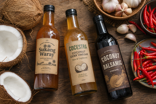 Coconut vinegar bottles on a farm table with fresh coconuts